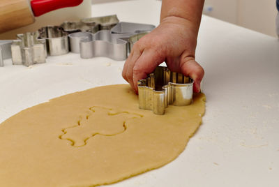 Midsection of person preparing cookies on table