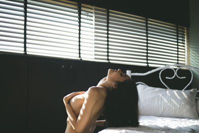 Young man resting on bed at home