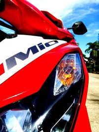 Close-up of red car against sky