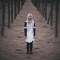 Portrait of smiling girl standing on field