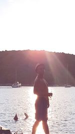 Man standing in lake against clear sky