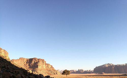 Scenic view of mountains against clear blue sky