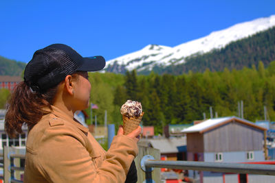 Side view of woman looking at mountain