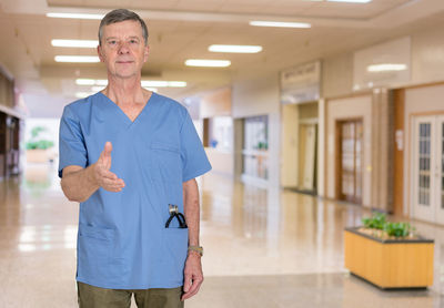 Full length portrait of man walking in corridor