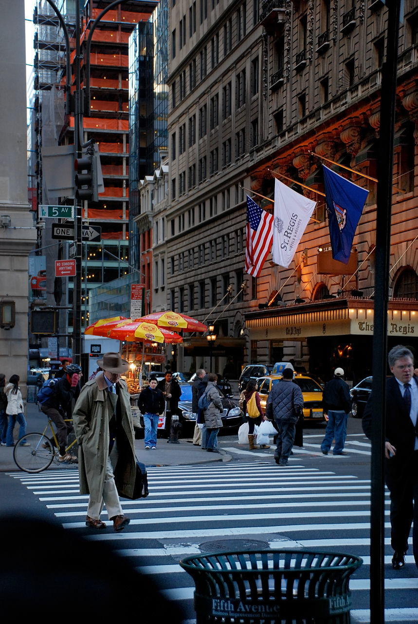 PEOPLE WALKING ON STREET IN TOWN SQUARE