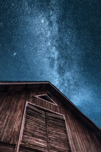 Low angle view of house against star field against at night