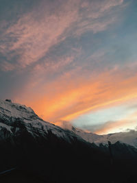 Scenic view of snowcapped mountains against sky during sunset