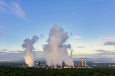 Smoke stacks against sky