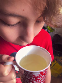 Close-up of woman holding cup of coffee