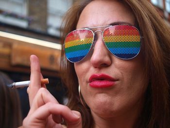 Close-up portrait of young woman wearing sunglasses