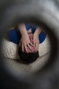 High angle view of woman lying on hand