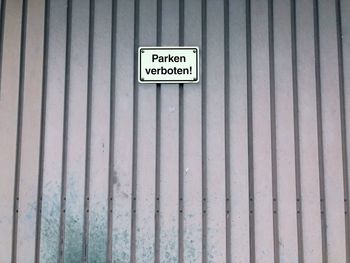 Close-up of information sign on wall
