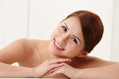 Portrait of smiling shirtless young woman at home