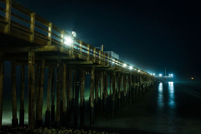 Illuminated bridge at night