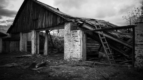 Abandoned house on field against sky