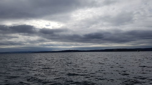 Scenic view of sea against storm clouds