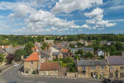 High angle view of buildings in town against sky