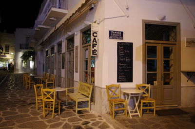 Chairs and tables in cafe against sky