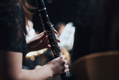 Close-up of woman playing musical instrument