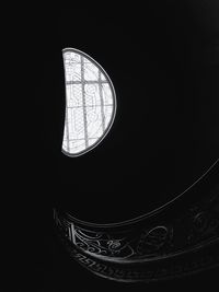 Low angle view of light bulb against black background