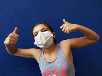 Portrait of boy against blue wall