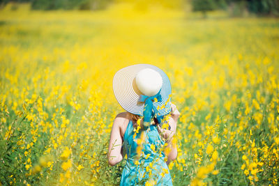 Person holding umbrella standing on field