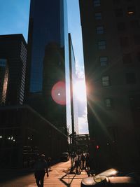 Sun shining through buildings in city