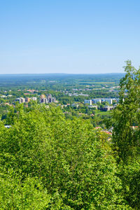 High angle view of townscape by sea against clear sky