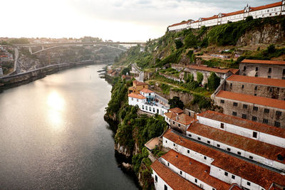 High angle view of river amidst buildings in town against sky