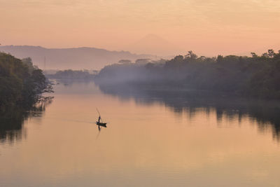 Scenic view of river against sky during sunrise
