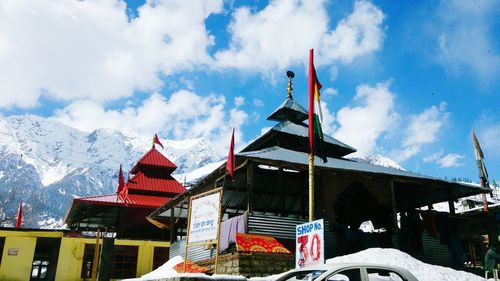 Low angle view of building against cloudy sky