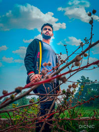 Low angle view of man standing against sky