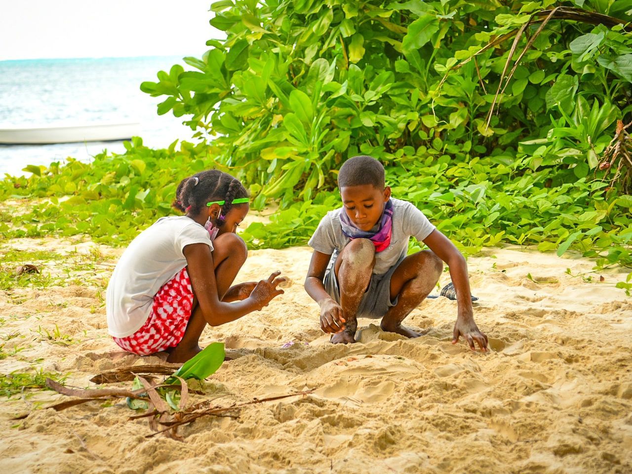 land, men, adult, two people, beach, togetherness, nature, sand, leisure activity, water, plant, sitting, lifestyles, women, bonding, friendship, day, full length, casual clothing, emotion, happiness, trip, vacation, female, sea, holiday, smiling, young adult, outdoors, crouching, relaxation, family, child, enjoyment, positive emotion, childhood, summer, mature adult, tropical climate, tree, travel, sunlight