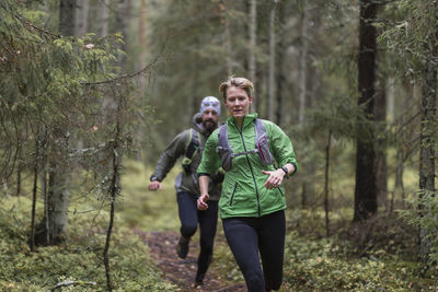 Man and woman running in forest