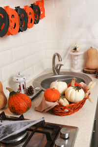 Interior halloween with pumpkins, spider web and garland in the kitchen. halloween home party