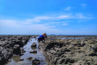 Panoramic shot of rocks on beach against sky