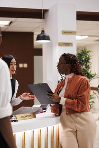 Side view of woman using digital tablet