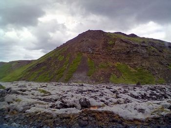 Scenic view of mountains against cloudy sky