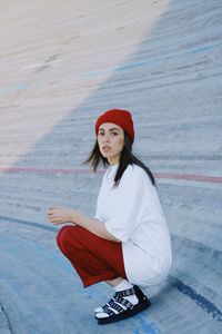 Portrait of young woman sitting outdoors