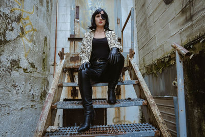 Portrait of young woman sitting on staircase