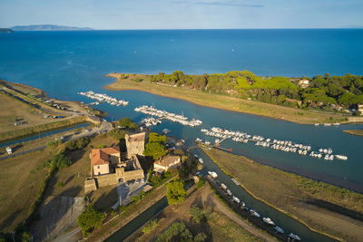 High angle view of sea and buildings against sky