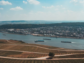 High angle view of cityscape by sea against sky