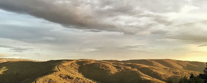 Scenic view of mountains against cloudy sky