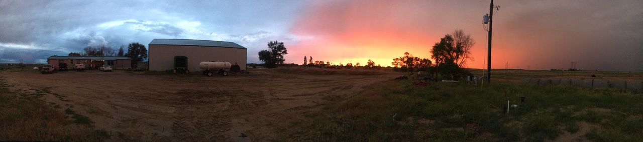 landscape, sunset, silhouette, tranquil scene, built structure, mid distance, tranquility, sky, architecture, solitude, cloud, building exterior, rural scene, silo, field, remote, scenics, dark, outdoors, beauty in nature, calm, non-urban scene, nature, countryside, cloud - sky, agriculture, country road, outline, farmhouse, dramatic sky, storm cloud