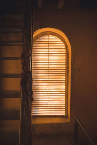 Yellow tinted blinds in a bell tower.