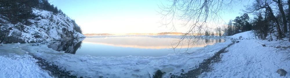 Panoramic shot of frozen lake against clear sky