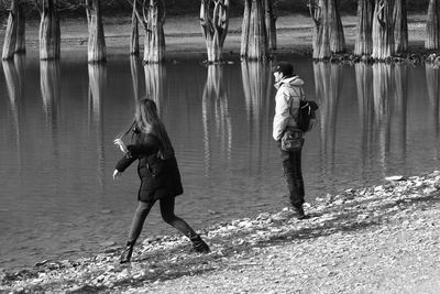 Rear view of people standing in water