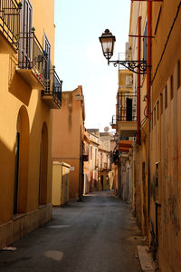 Empty alley amidst buildings in city