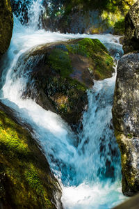 Scenic view of river flowing through rocks