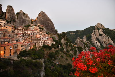 High angle view of townscape and mountains against clear sky